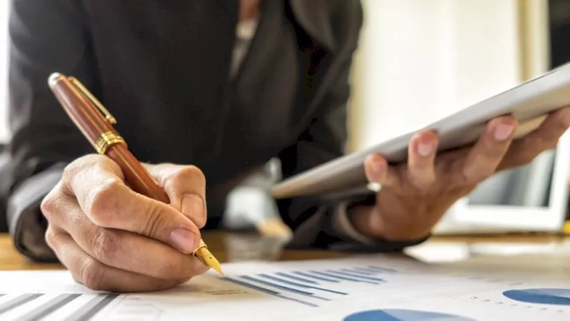 Businesswomen analyzing investment charts