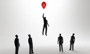 Man floating with balloon